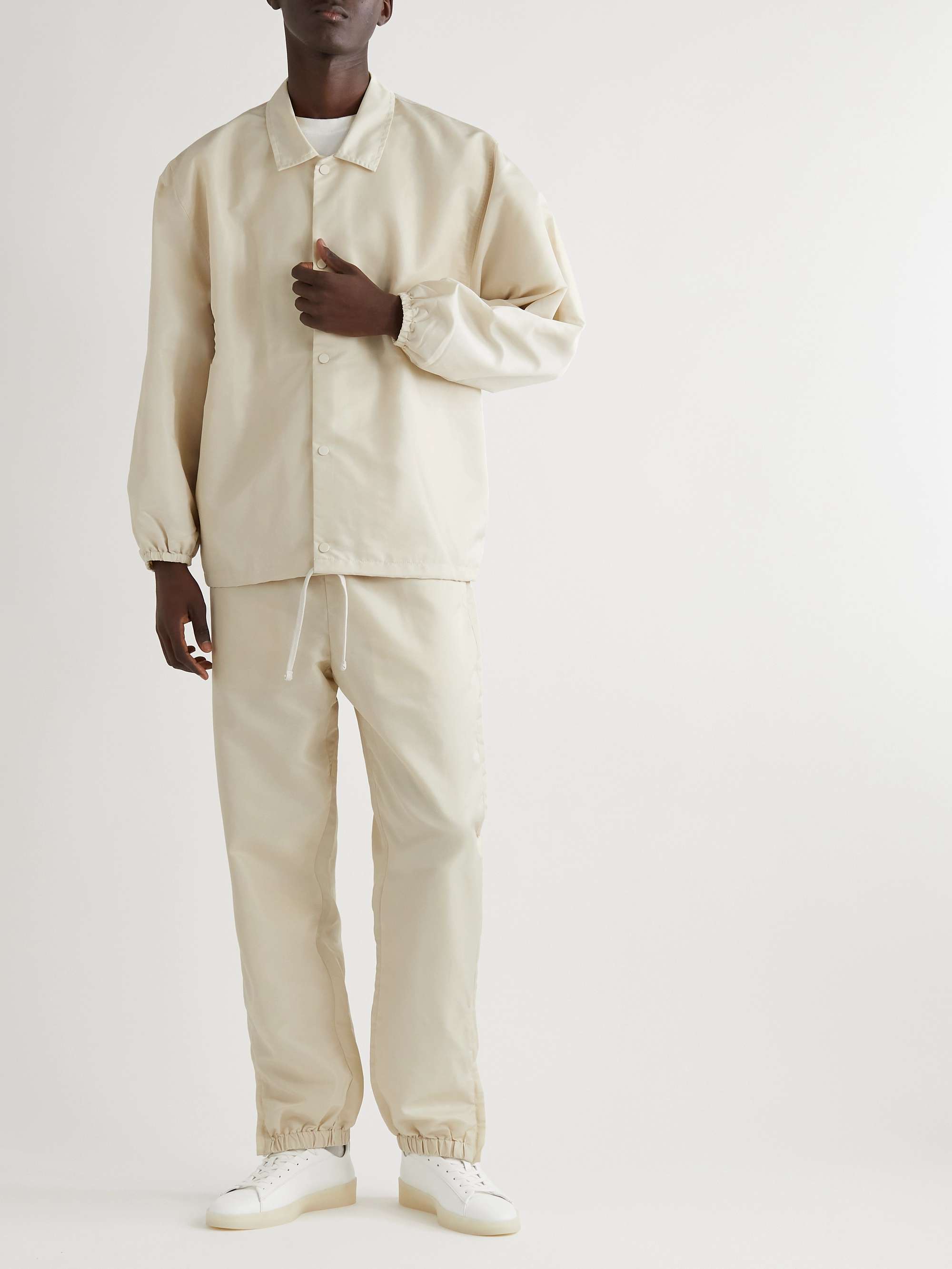 FEAR OF GOD ESSENTIALS Slim-Fit Tapered Logo-Appliquéd Nylon Sweatpants for  Men | MR PORTER