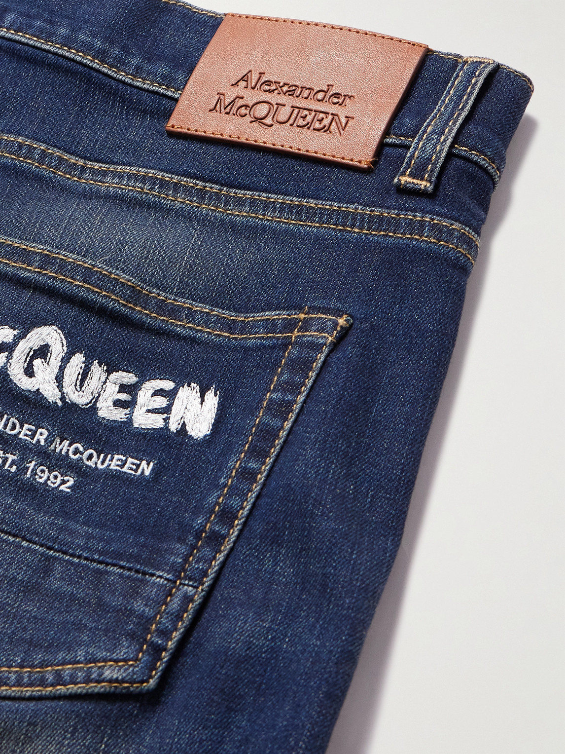 Shop Alexander Mcqueen Graffiti Straight-leg Logo-embroidered Jeans In Blue