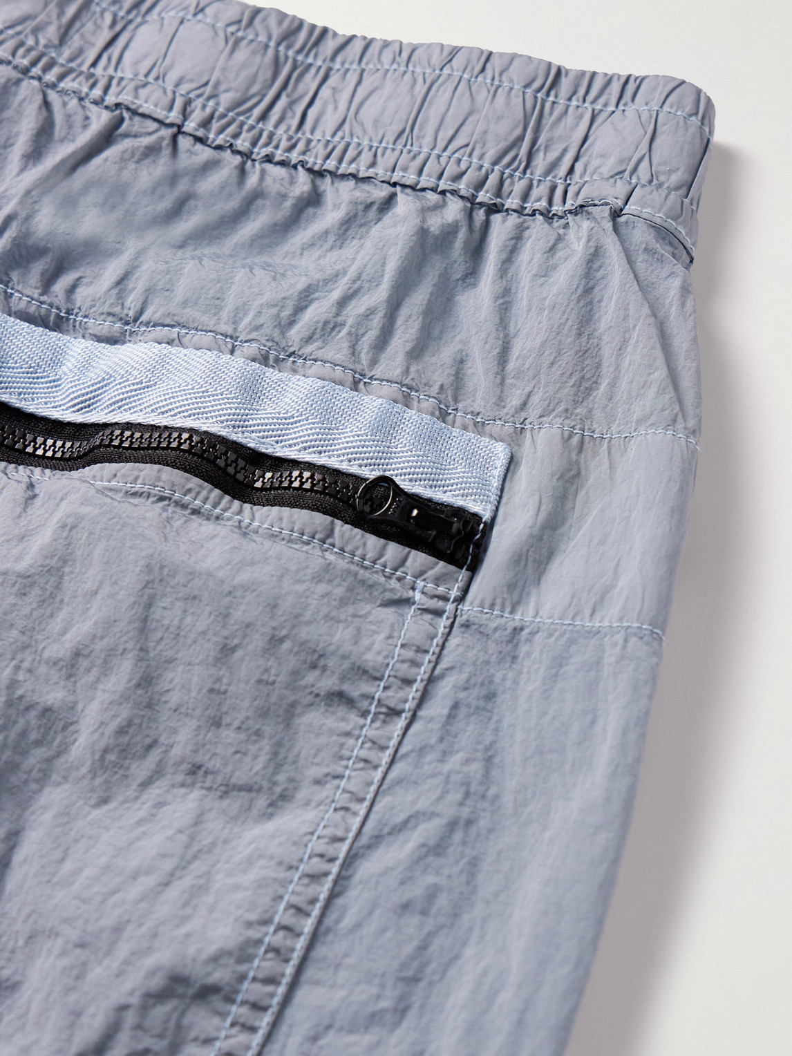 Shop Stone Island Tapered Logo-appliquéd Econyl® Nylon Metal Trousers In Blue